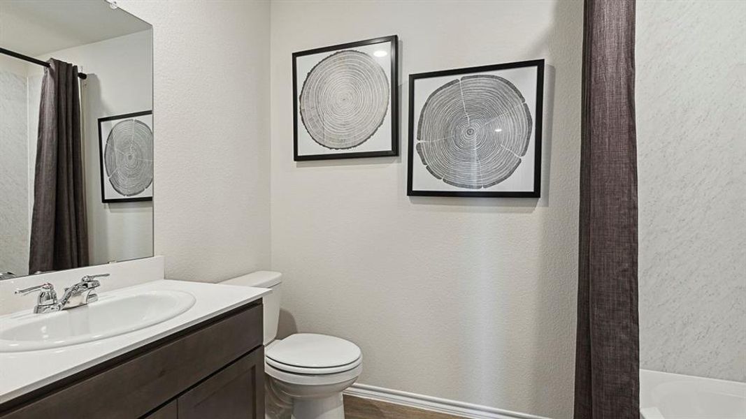 Bathroom featuring a white vanity with a single sink, chrome faucet, and a mirror