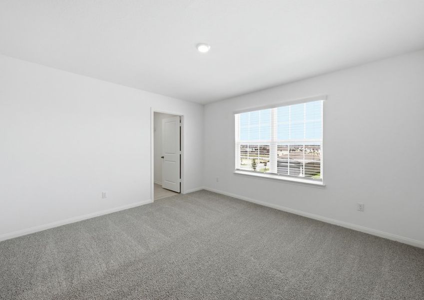 Second-floor game room featuring a window with natural light and wood-look vinyl flooring. Second-floor game room featuring a window with natural light and wood-look vinyl flooring.