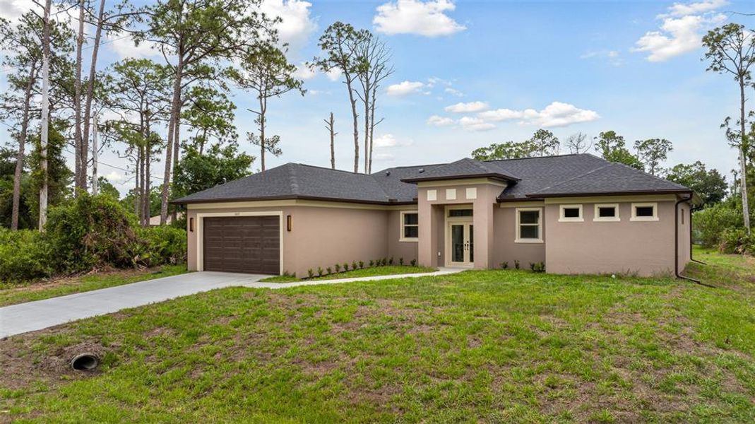 Front exterior of a new home in , North Port, FL, highlighting curb appeal (Image 26). Front exterior of a new home in , North Port, FL, highlighting curb appeal (Image 26).