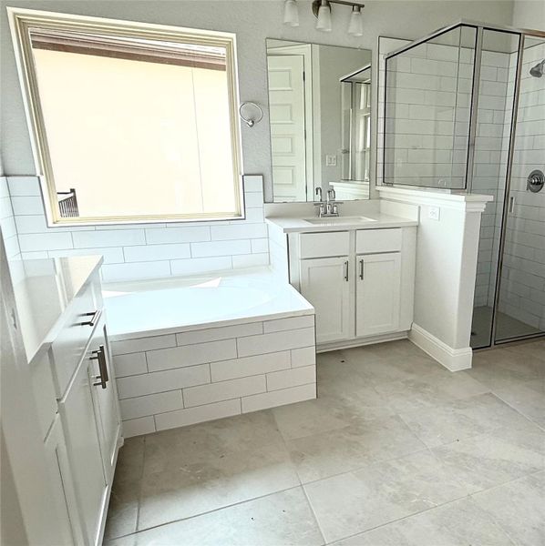 Full bathroom with vanity, a bath, a shower stall, and tile patterned flooring Full bathroom with vanity, a bath, a shower stall, and tile patterned flooring