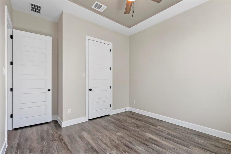 Unfurnished bedroom featuring dark hardwood / wood-style floors