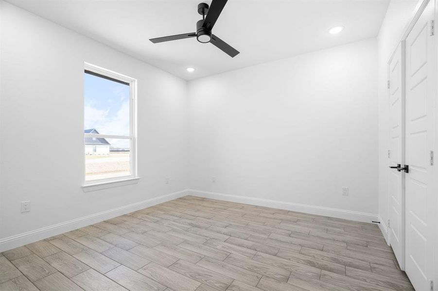 Unfurnished room featuring ceiling fan and light wood-type flooring