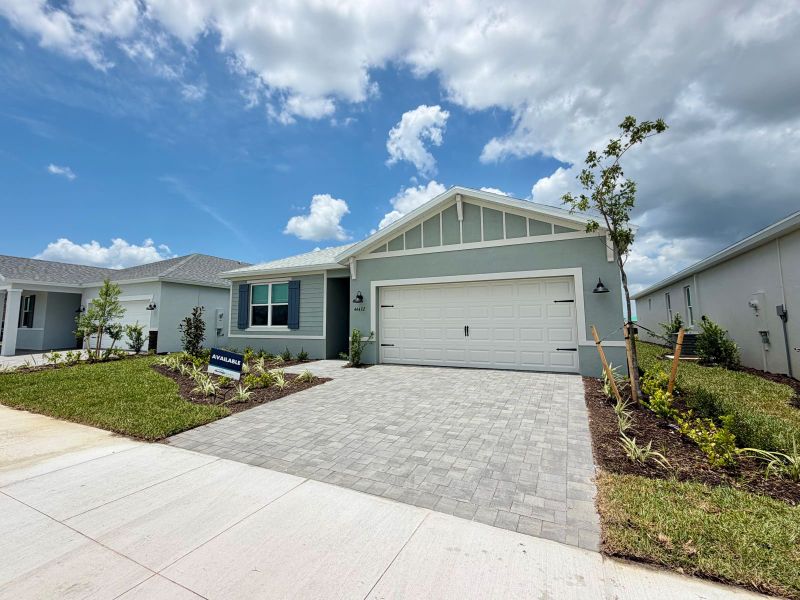 Front exterior of a new home in Crescent Lakes - Reserve Series, Punta Gorda, FL, highlighting curb appeal (Image 9). Front exterior of a new home in Crescent Lakes - Reserve Series, Punta Gorda, FL, highlighting curb appeal (Image 9).