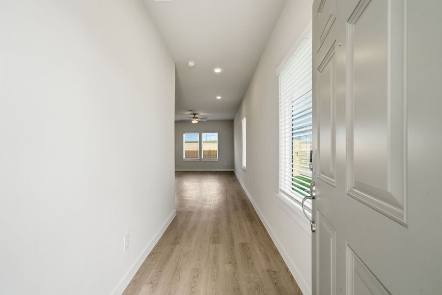 A hallway with white walls.