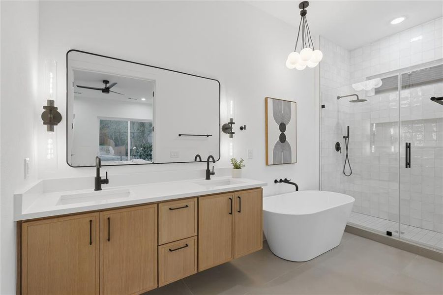 Bathroom with double vanity, a shower stall, a freestanding tub, recessed lighting, and a ceiling fan