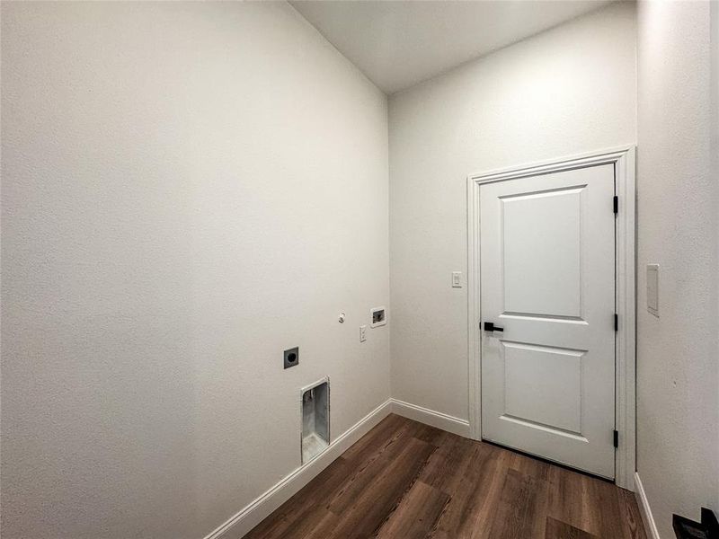 Washroom featuring electric dryer hookup, dark wood-style flooring, baseboards, hookup for a washing machine, and gas dryer hookup Washroom featuring electric dryer hookup, dark wood-style flooring, baseboards, hookup for a washing machine, and gas dryer hookup
