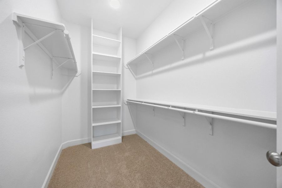 Space for Everything: Miles of hang space and custom shelves adorn boatloads of storage across two distinct primary closets.