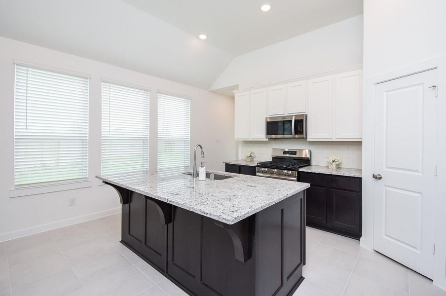 Another wall of windows lights this gorgeous kitchen area.