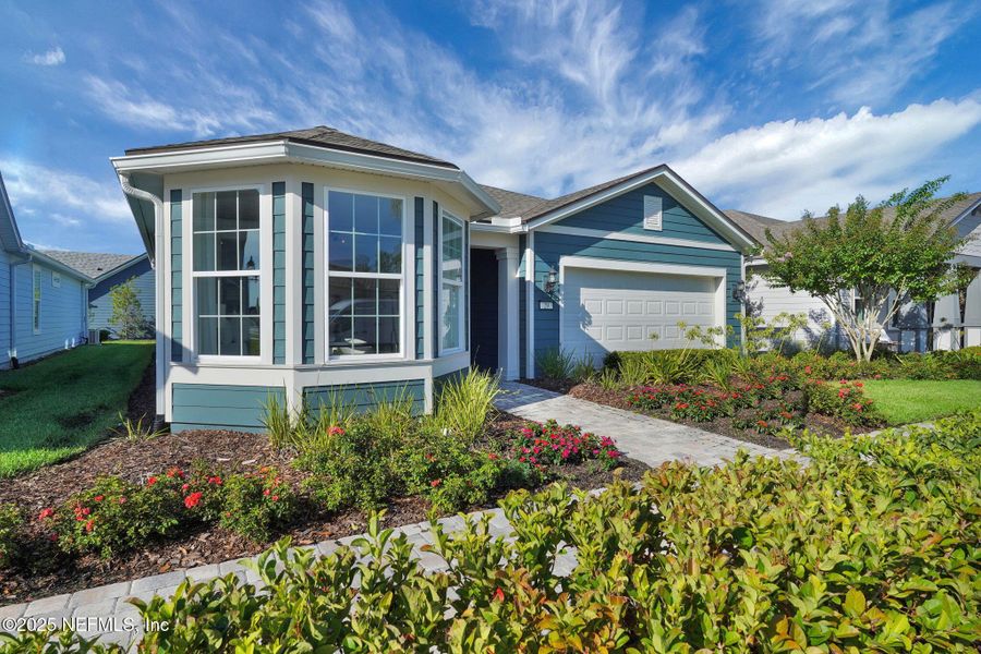 Front exterior of a new home in Summer Bay at Grand Oaks, St. Augustine, FL, highlighting curb appeal (Image 24). Front exterior of a new home in Summer Bay at Grand Oaks, St. Augustine, FL, highlighting curb appeal (Image 24).
