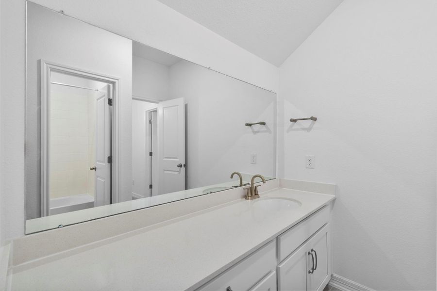 Thoughtfully designed, this secondary bedroom provides versatility with an oversized vanity.