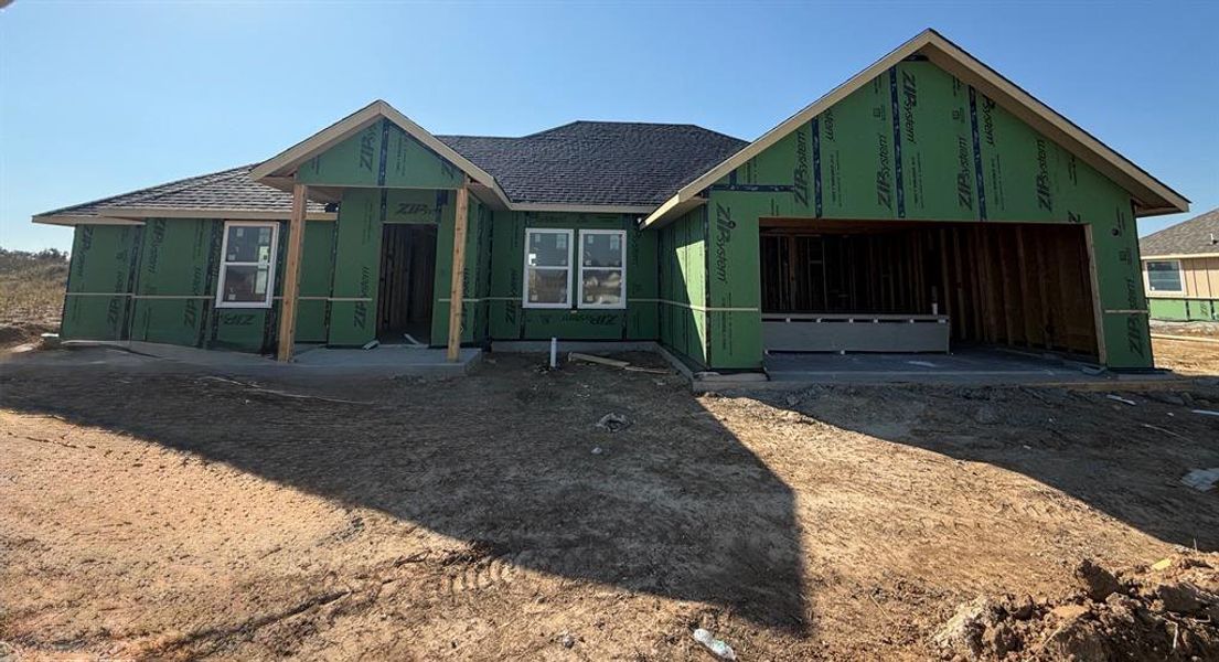 Property in mid-construction with roof with shingles