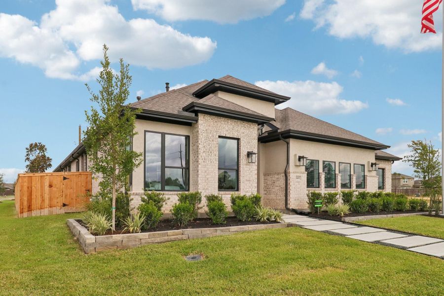 Front exterior of a new home in The Woodlands Hills, Willis, TX, highlighting curb appeal (Image 23).