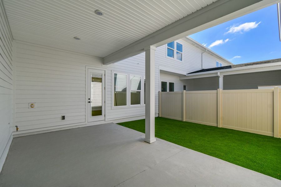 Exterior details and patio area of a home in Seven Pines 24' Rear Entry Townhomes, Jacksonville (Image 3).