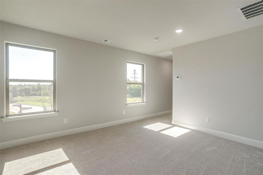 Empty room with light colored carpet and recessed lighting Empty room with light colored carpet and recessed lighting