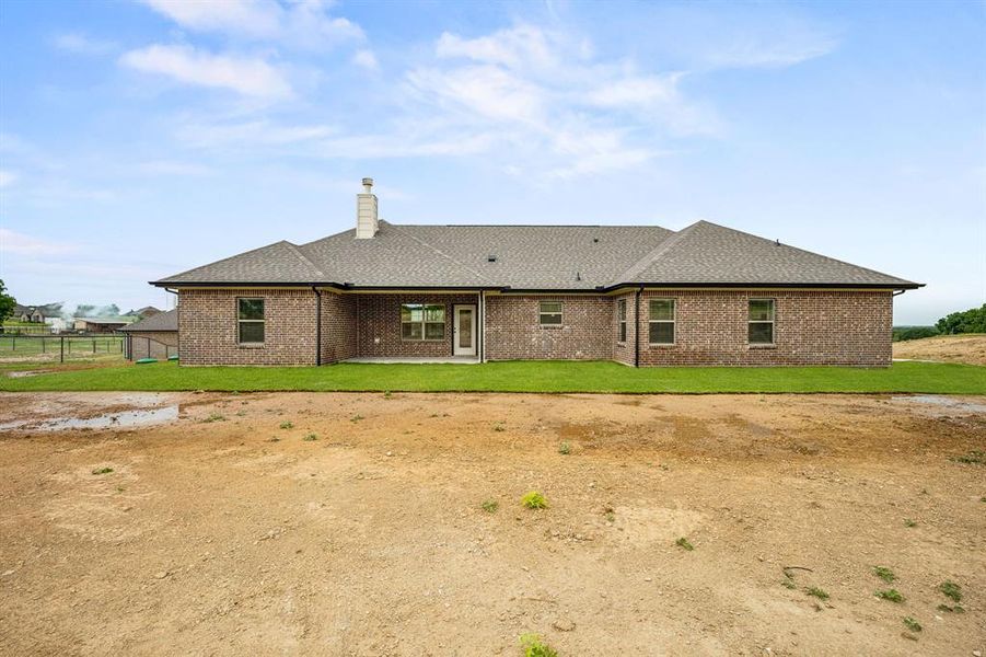 Back of property with a patio