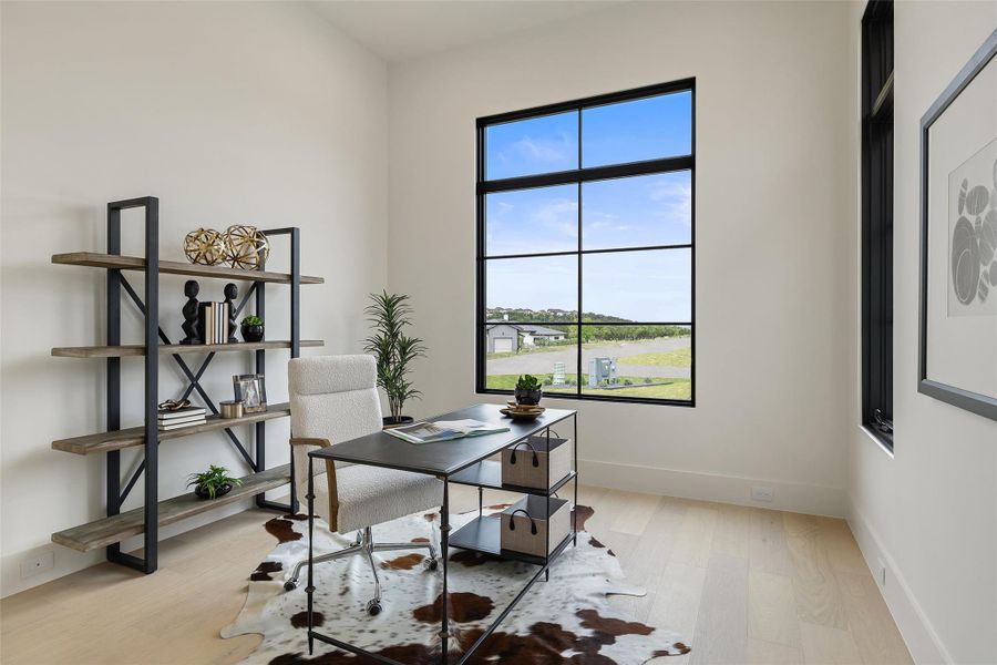 Home office with light wood-type flooring and baseboards Home office with light wood-type flooring and baseboards