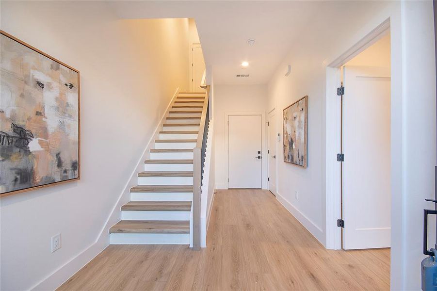 Stairs featuring wood finished floors and recessed lighting Stairs featuring wood finished floors and recessed lighting