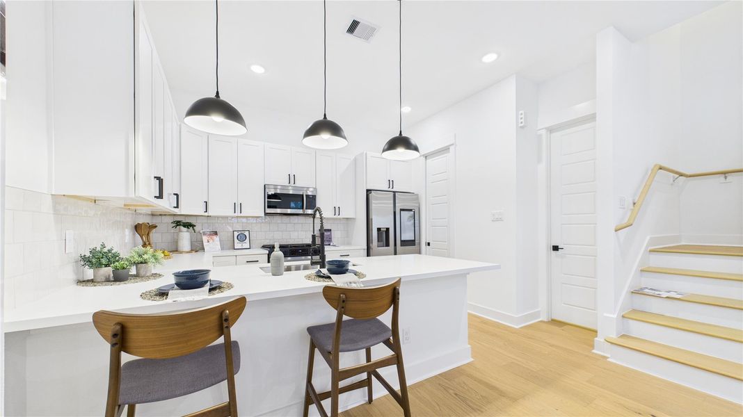 This beautifully designed open-concept kitchen is the perfect blend of style and functionality. Featuring a spacious kitchen peninsula, sleek stainless steel appliances, and ample countertop space, it offers a modern cooking and entertaining experience. The open layout seamlessly connects to the living and dining areas, creating a welcoming environment ideal for gatherings or everyday meals. Thoughtful design elements, quality finishes, and generous workspace make this kitchen a true standout in any home. This beautifully designed open-concept kitchen is the perfect blend of style and functionality. Featuring a spacious kitchen peninsula, sleek stainless steel appliances, and ample countertop space, it offers a modern cooking and entertaining experience. The open layout seamlessly connects to the living and dining areas, creating a welcoming environment ideal for gatherings or everyday meals. Thoughtful design elements, quality finishes, and generous workspace make this kitchen a true standout in any home.