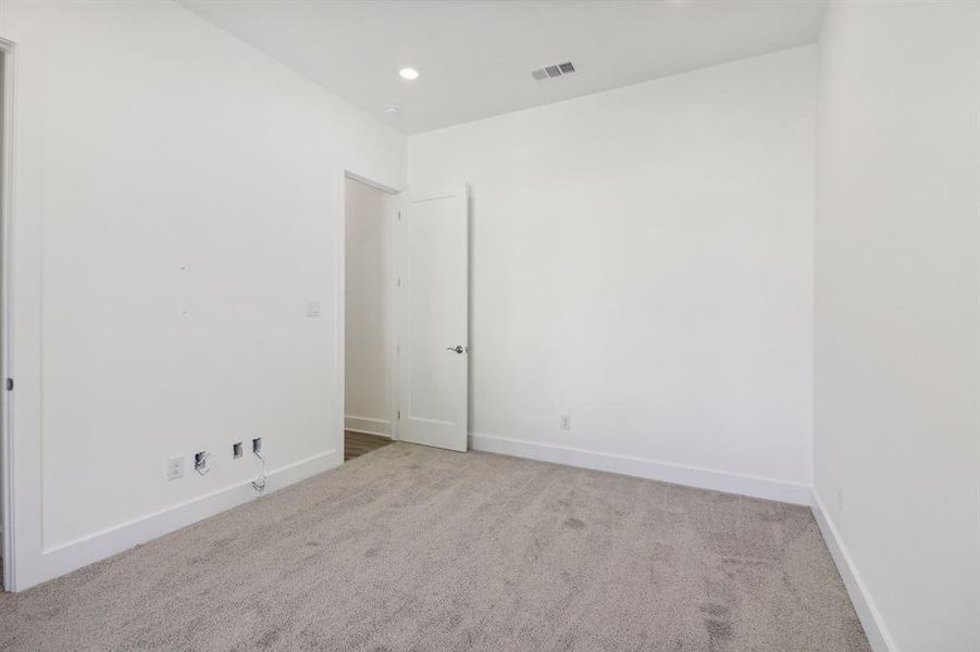 Spare room with light carpet and recessed lighting