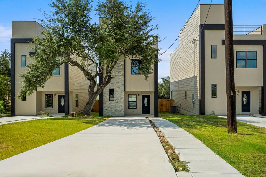 Modern home featuring stucco siding and stone siding