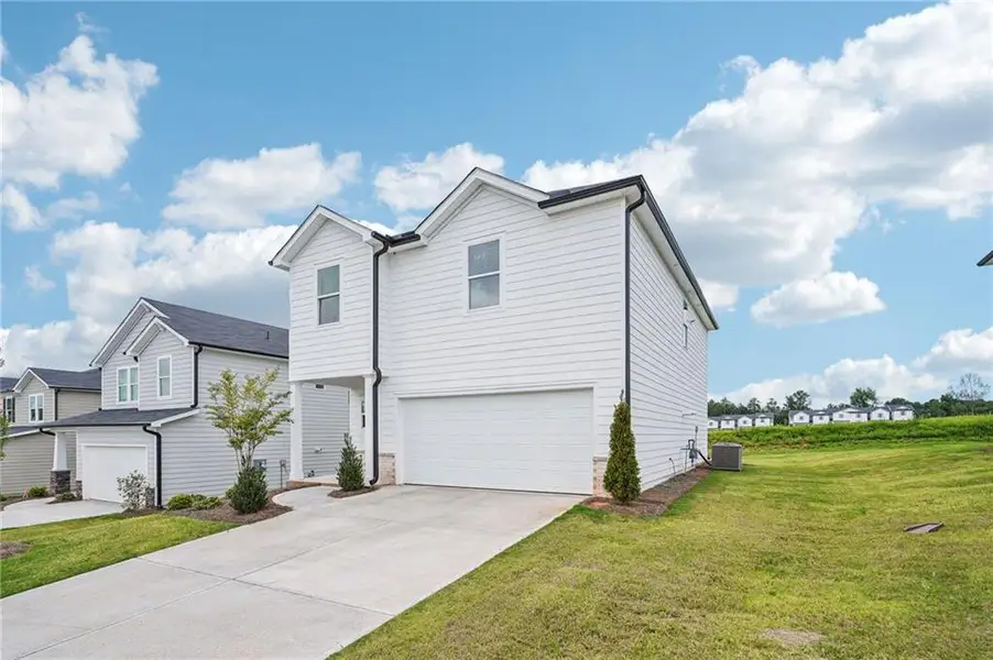 Front exterior of a new home in Avalon - Reserve Series, Conyers, GA, highlighting curb appeal (Image 1).