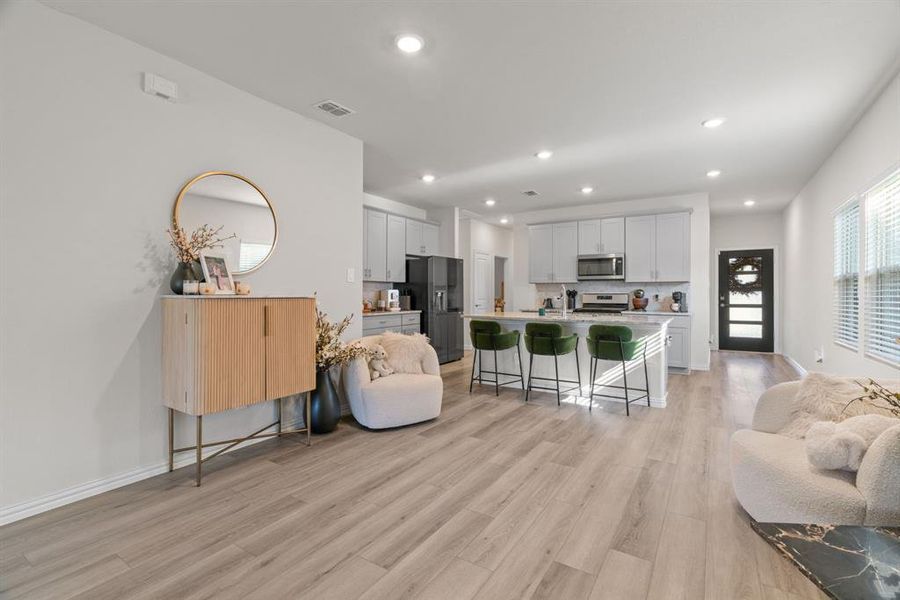 Living area with recessed lighting and light wood-style flooring Living area with recessed lighting and light wood-style flooring