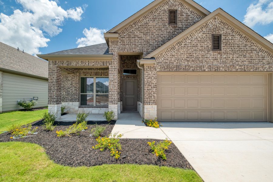 Front exterior of a new home in Prairie Winds, Hutto, TX, highlighting curb appeal (Image 20).