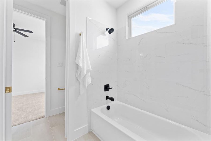Full bath featuring shower / tub combination, light carpet, and ceiling fan