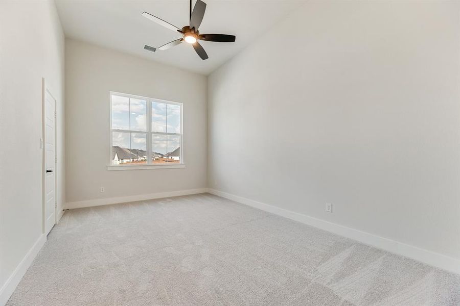 Empty room with light colored carpet and ceiling fan Empty room with light colored carpet and ceiling fan
