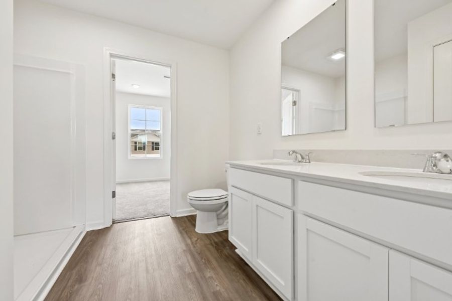 A bathroom with white cabinets. A bathroom with white cabinets.