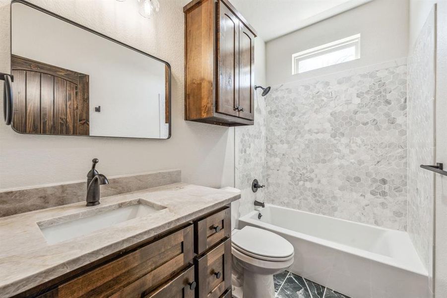 Full bathroom featuring toilet, vanity, and shower / bathtub combination