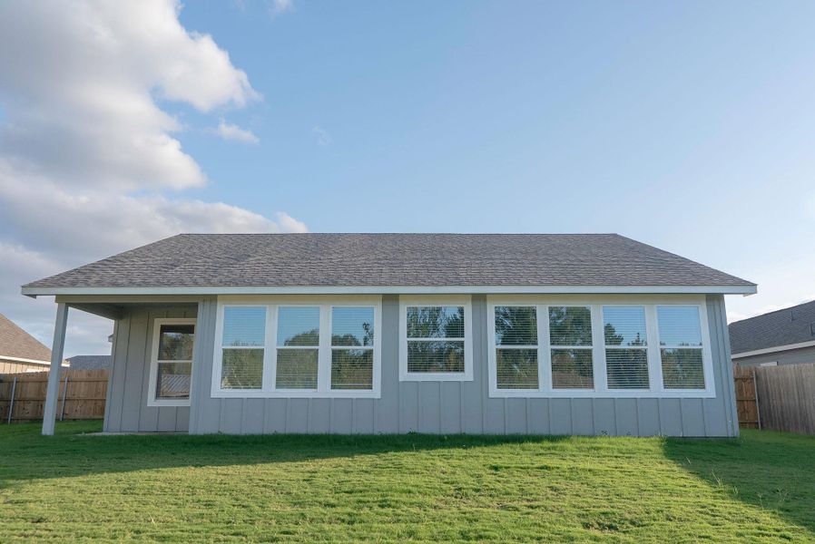 Rear view of property featuring roof with shingles and board and batten siding Rear view of property featuring roof with shingles and board and batten siding