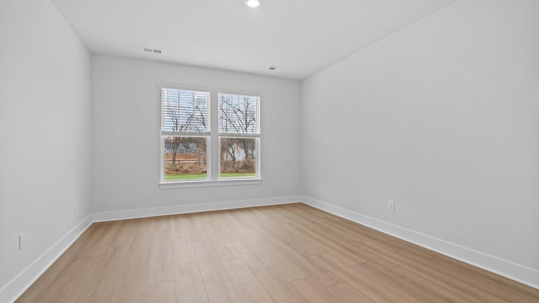 Vibrant natural light fills this exceptional primary suite with eye-catching details