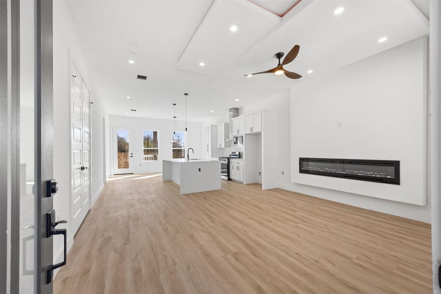 Entryway, with living room- leading into the kitchen.