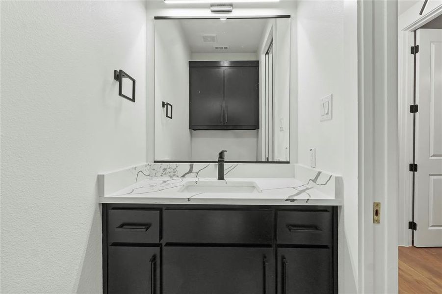 Bathroom featuring vanity and light wood finished floors Bathroom featuring vanity and light wood finished floors