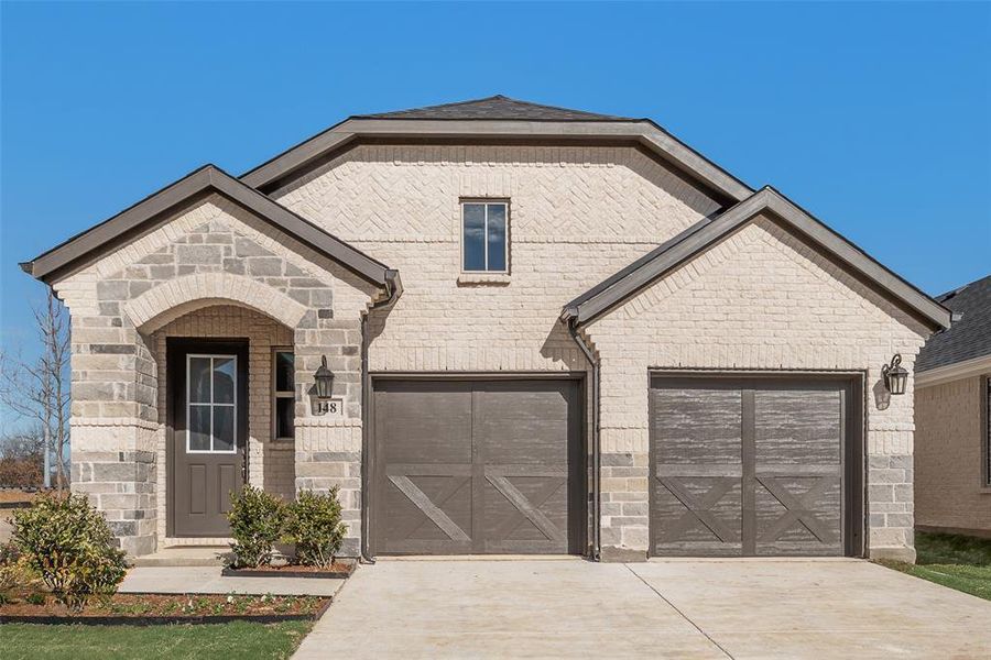 Front exterior of a new home in Spiritas Ranch, Little Elm, TX, highlighting curb appeal (Image 19).