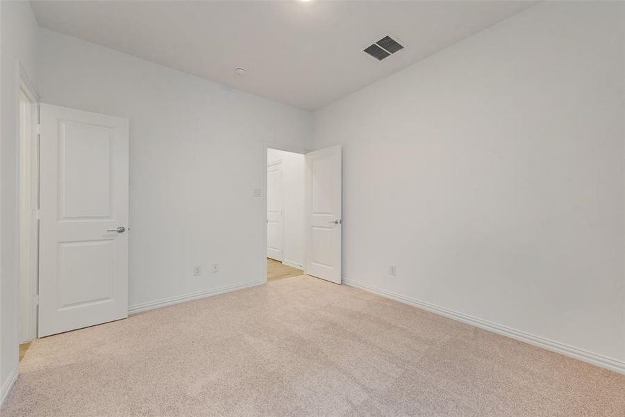 Unfurnished room featuring light colored carpet