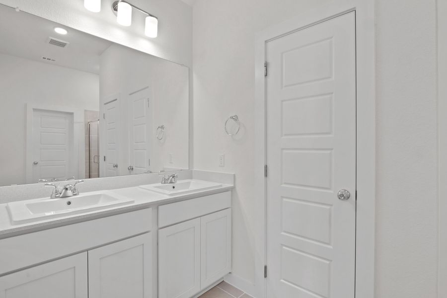 Primary Bathroom in the Pecan II home plan by Trophy Signature Homes – REPRESENTATIVE PHOTO