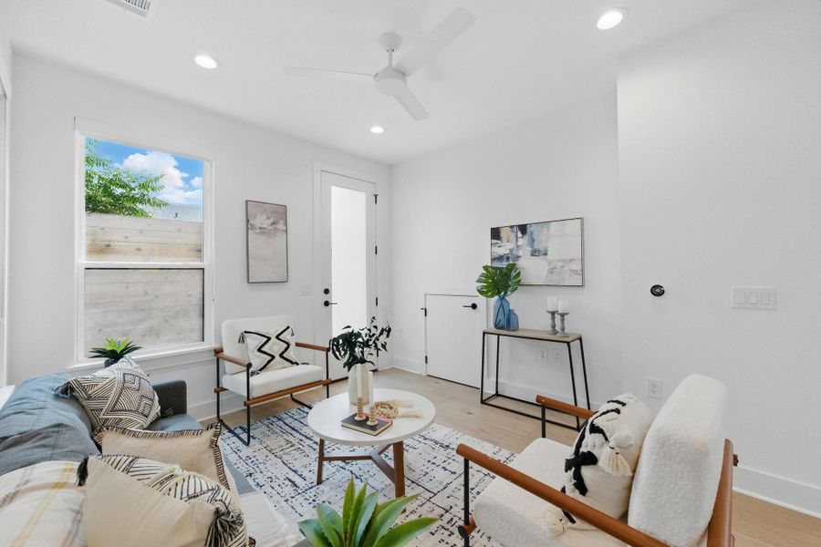Living area featuring wood finished floors, recessed lighting, and ceiling fan Living area featuring wood finished floors, recessed lighting, and ceiling fan
