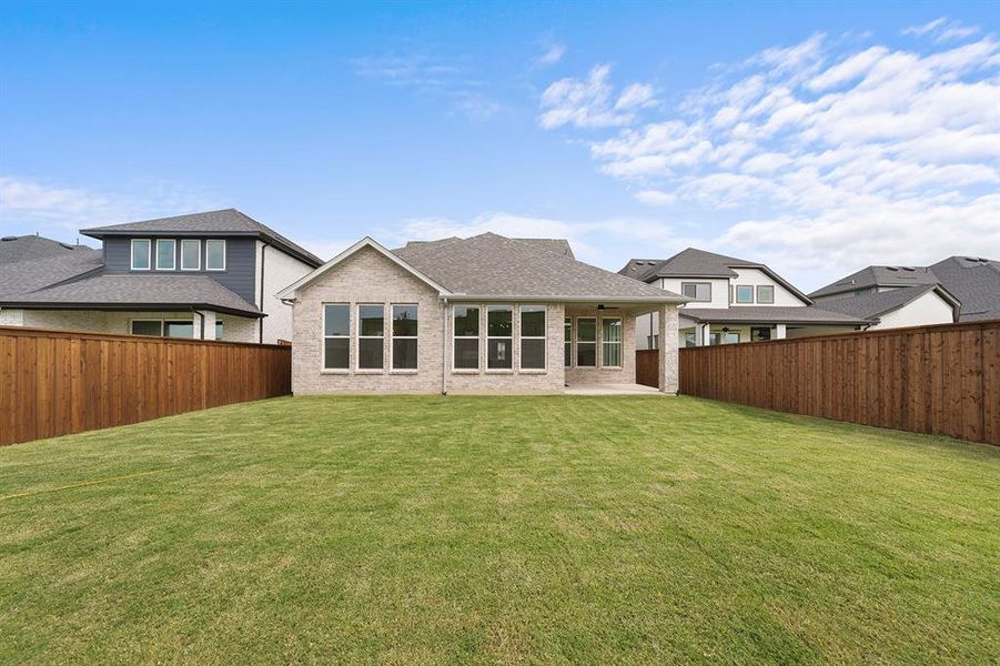 Back of house featuring a patio, a fenced backyard, brick siding, and a shingled roof Back of house featuring a patio, a fenced backyard, brick siding, and a shingled roof