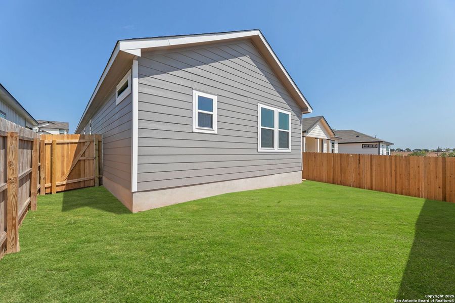 Front exterior of a new home in Highland Ridge, New Braunfels, TX, highlighting curb appeal (Image 1).