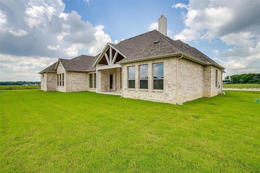 Back of house featuring a lawn