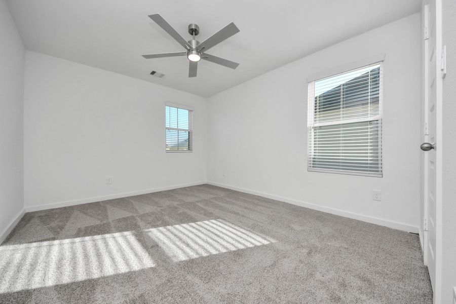Secondary bedroom features plush carpeting, large windows that let in plenty of natural light, bright paint, and spacious closets. Secondary bedroom features plush carpeting, large windows that let in plenty of natural light, bright paint, and spacious closets.