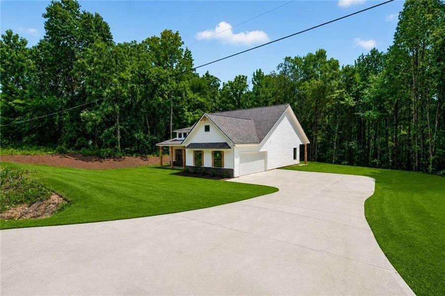 Front exterior of a new home in , Silver Creek, GA, highlighting curb appeal (Image 2). Front exterior of a new home in , Silver Creek, GA, highlighting curb appeal (Image 2).