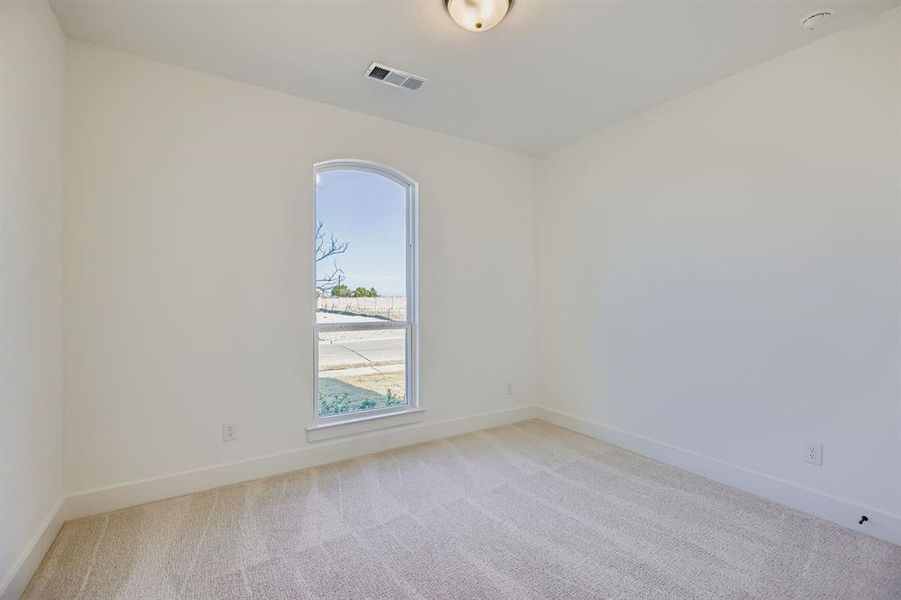 Empty room with light carpet and baseboards Empty room with light carpet and baseboards