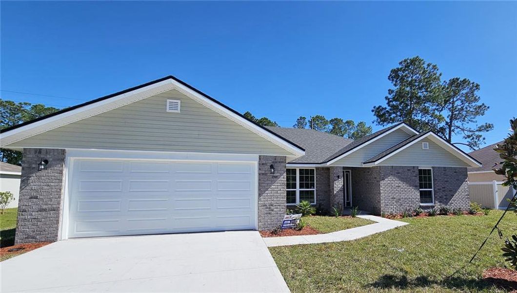 Front exterior of a new home in Palm Coast, Palm Coast, FL, highlighting curb appeal (Image 1).