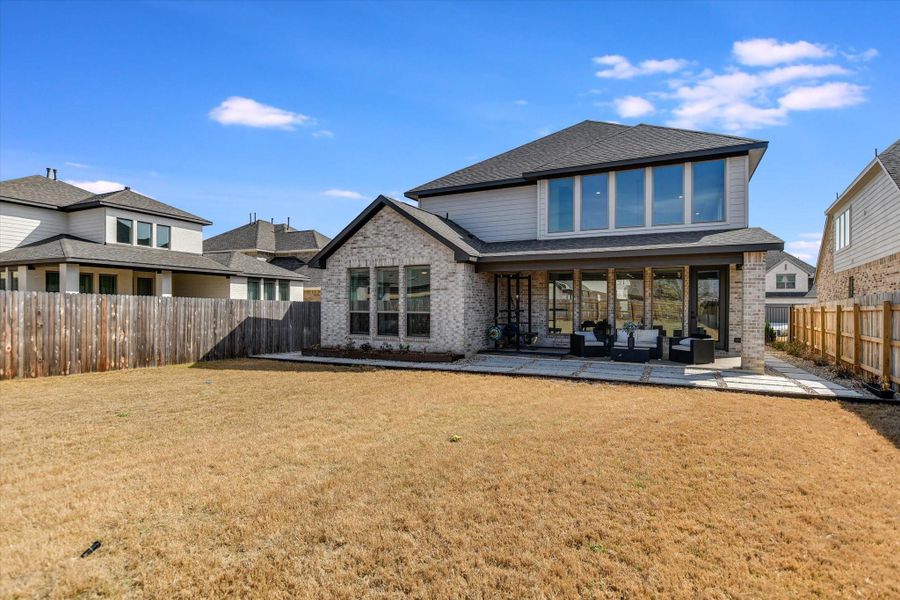 Front exterior of a new home in Santa Rita Ranch 50', Liberty Hill, TX, highlighting curb appeal (Image 1).