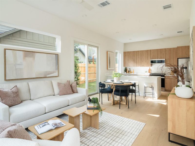 Open-concept living space featuring wood-finish flooring, recessed lighting, and a sliding glass door to the exterior