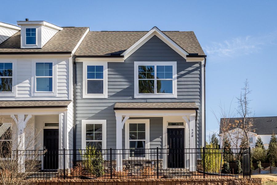 Front exterior of a new home in Enclave at Traditions Townhomes, Wake Forest, NC, highlighting curb appeal (Image 1). Front exterior of a new home in Enclave at Traditions Townhomes, Wake Forest, NC, highlighting curb appeal (Image 1).