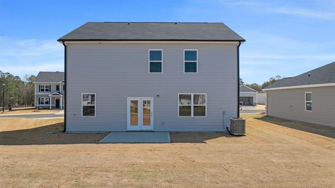 Front exterior of a new home in Champion's Run, Lithonia, GA, highlighting curb appeal (Image 20).